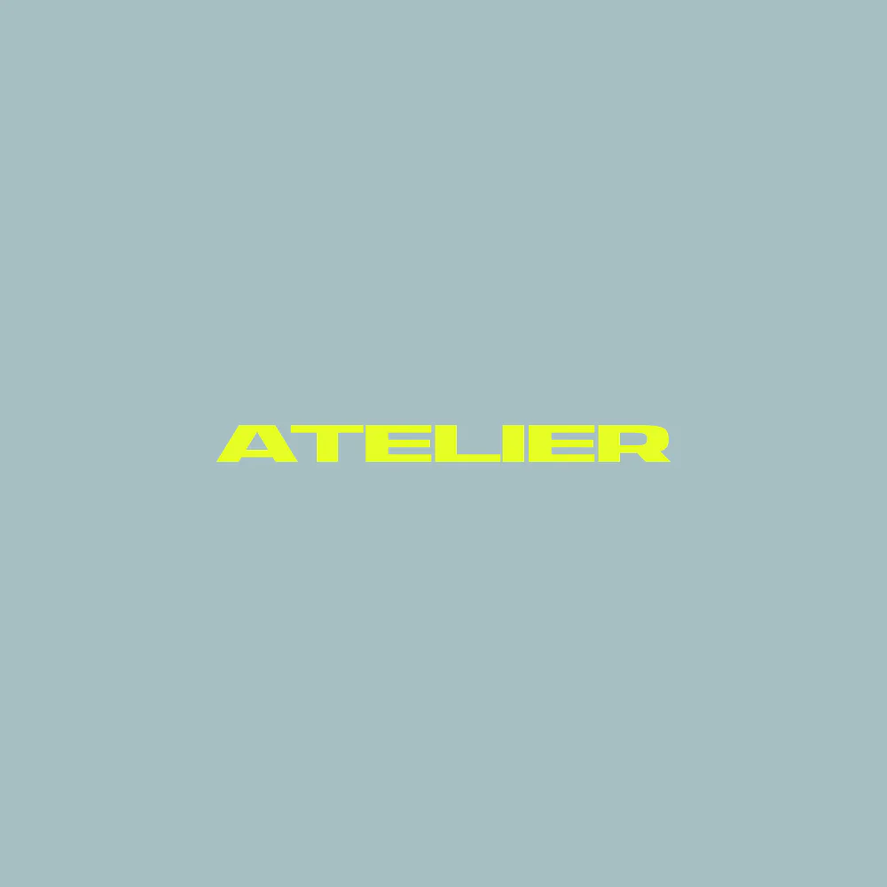 Atelier wordmark in fluorescent yellow on a pale blue background