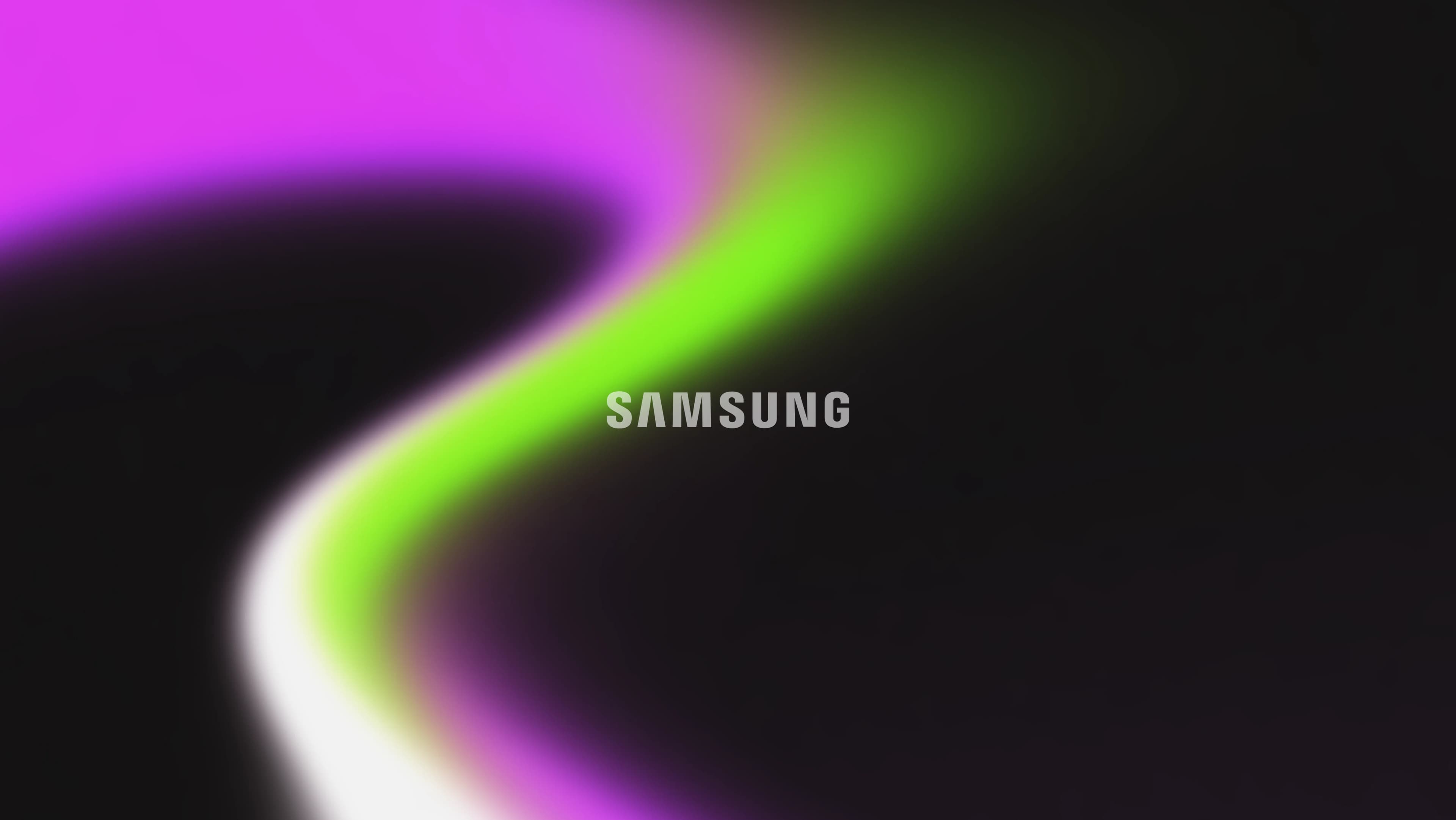 Samsung wordmark over blurred magenta and green light