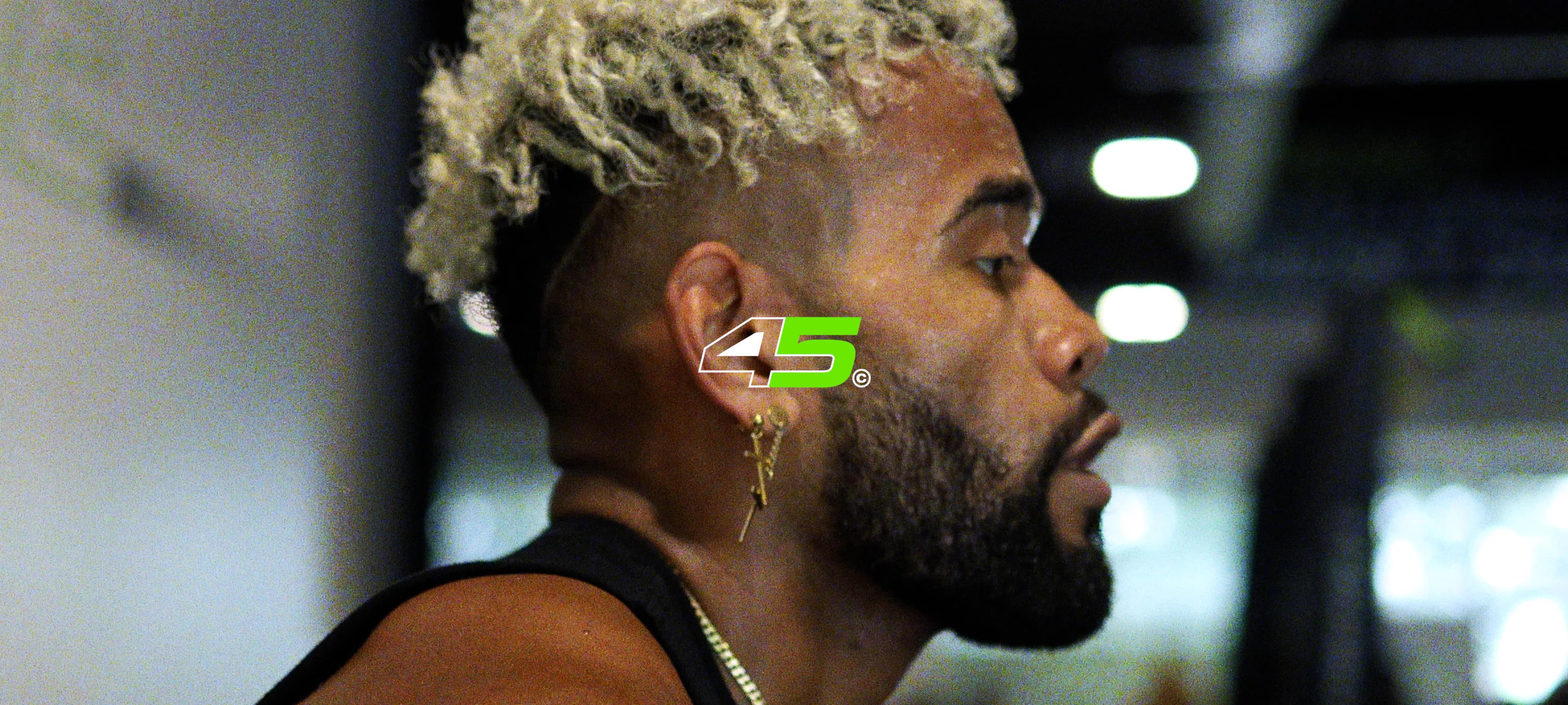 Male athlete portrait with a fluorescent green face mark