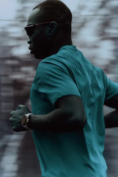 Runner in a teal shirt photographed from the side